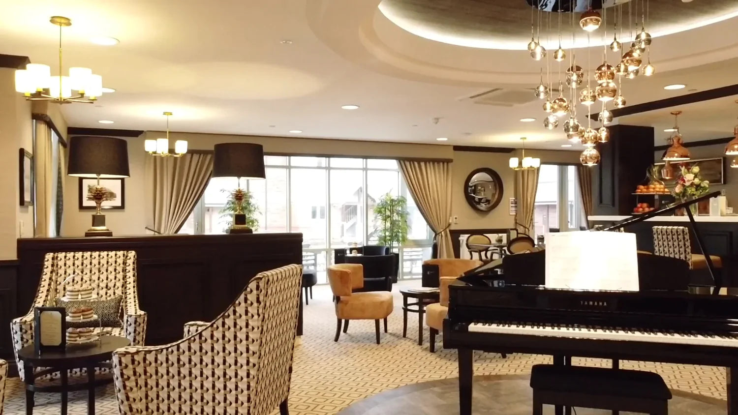 Interior view of a stylish new nursing home lounge with chairs and a piano.